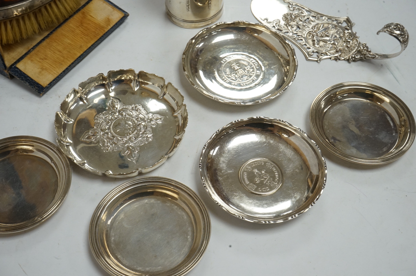 A set of three Elizabeth II small silver nut dishes, Birmingham, 1953, one other silver nut dish, two Chinese coin inset dishes, one made by Tack Hing, together with an 800 standard server, a silver scent bottle holder a